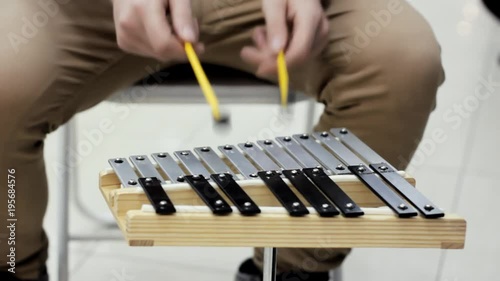 A man is playing on a metalophone.
