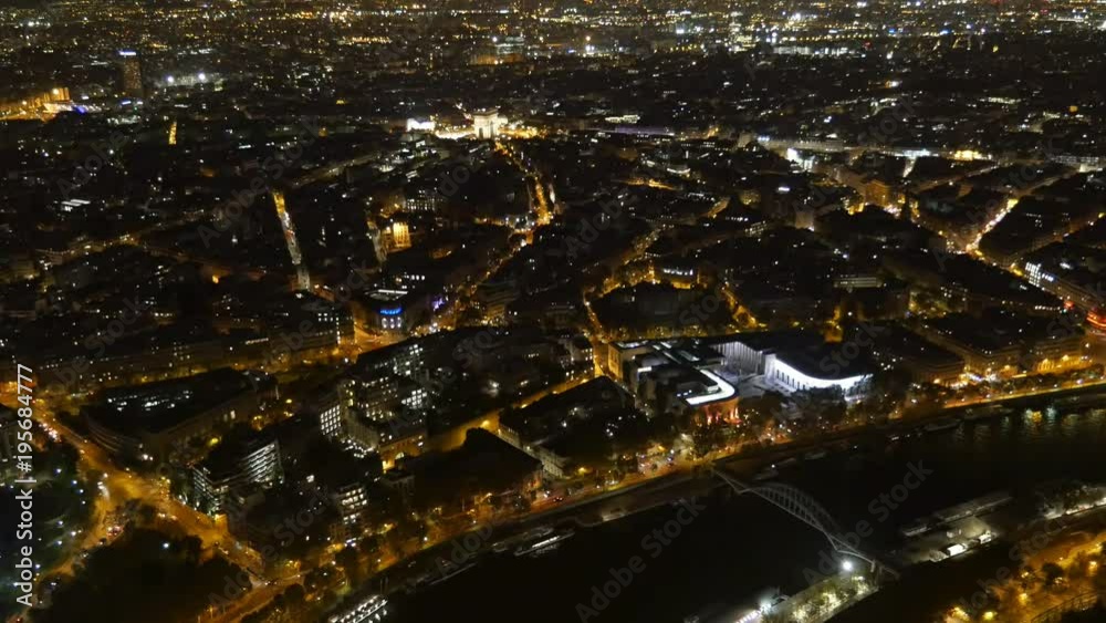 A magic bird`s eye view of the Seine embankments and Alexander pont covered with shining golden illumination rays deep at night in autumn A magic bird`s eye view of the Seine embankments and Alexander pont covered with shining golden illumination rays deep at night in autumn