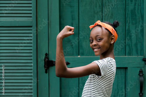 An african american tween girl being strong