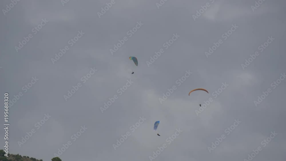 Adventurers paragliding in the sky Adventurers paragliding in the sky