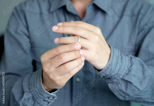 A man is wearing a wedding ring at his finger hands.
