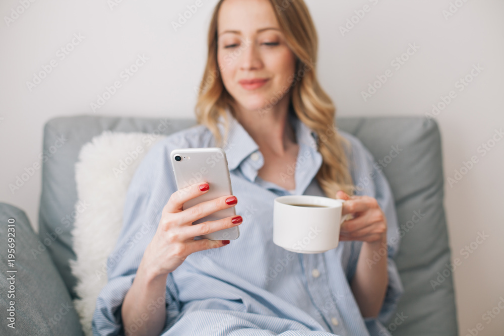 Woman browsing on her mobile phone indoor Woman browsing on her mobile phone indoor