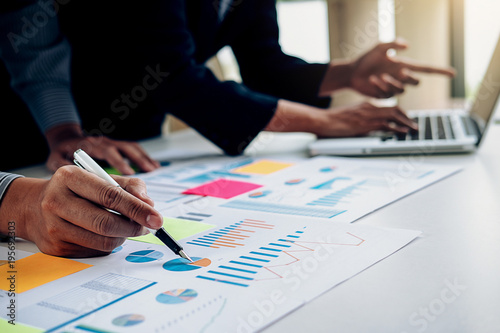 Business concept. Business people discussing the charts and graphs showing the results of their successful teamwork.