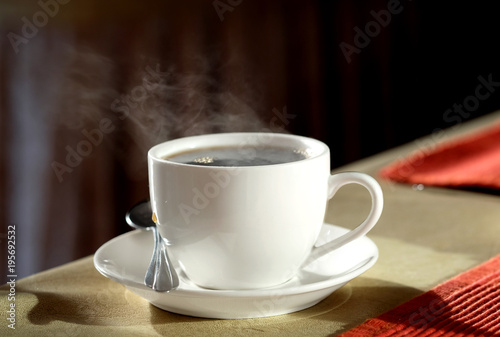 Hot coffee is smoked on the table in the morning