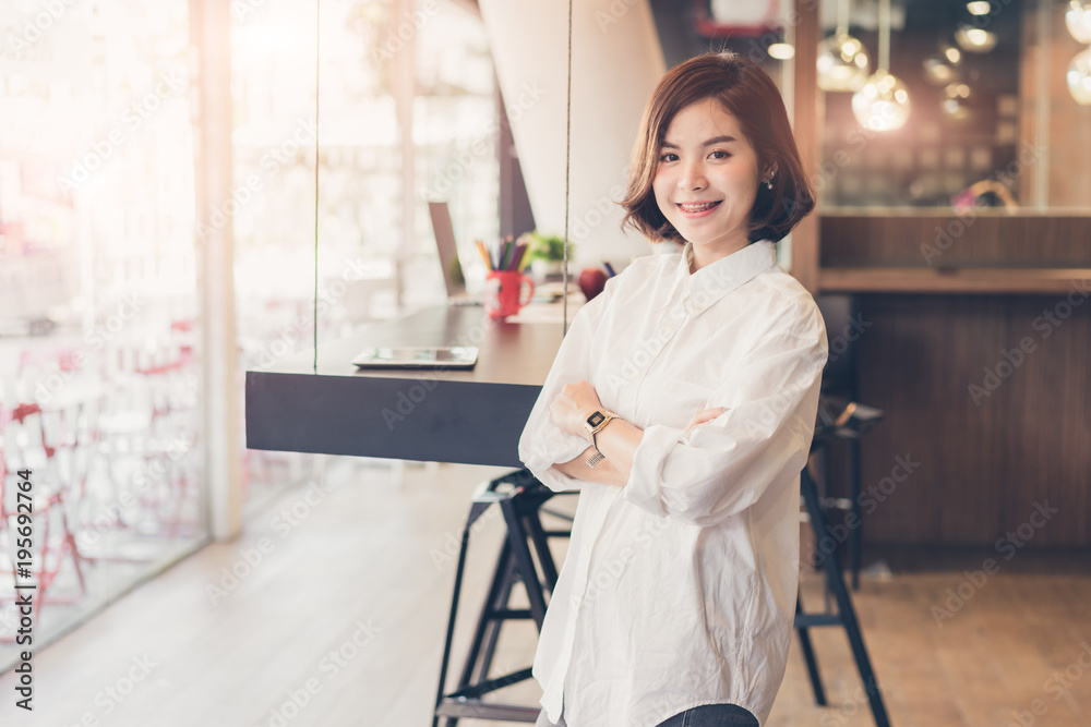 Beautiful business woman standing cross one's arm in coworking spaces. Beautiful business woman standing cross one's arm in coworking spaces.