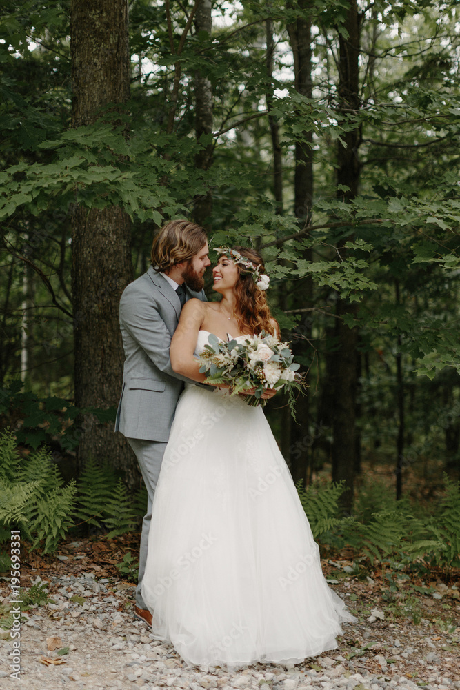 Newlywed couple embracing outdoors