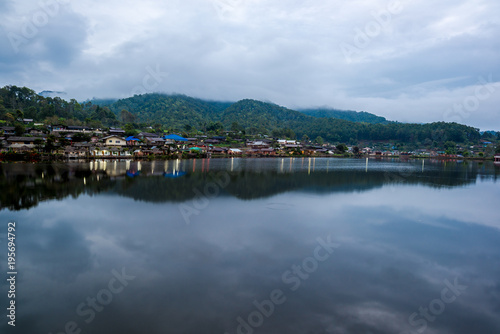Water Village at the edge of river in front of the mountain in countryside of Thailand