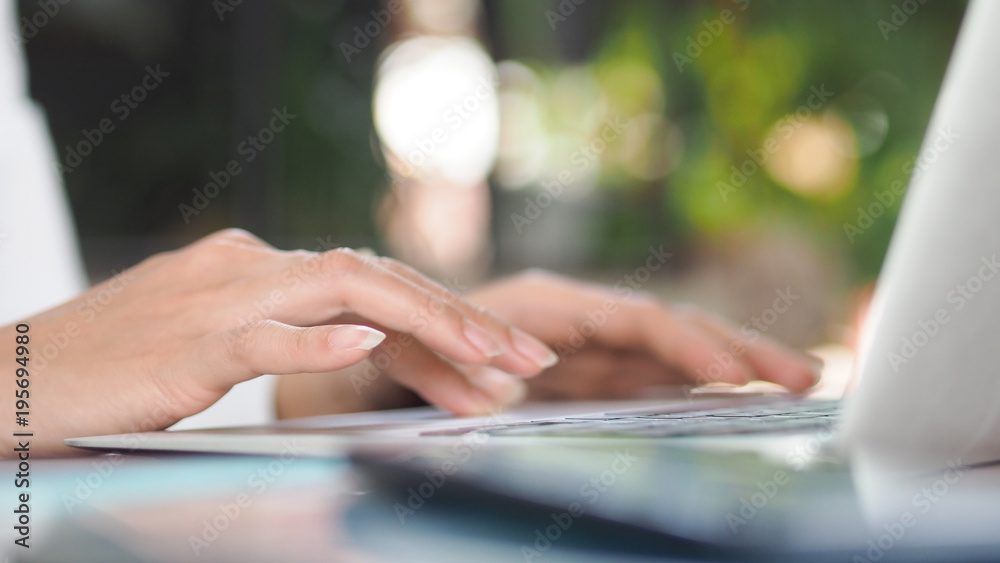 Blurred image, business woman hand typing on keyboards laptop computer on workplace in office, business and education technology concepts