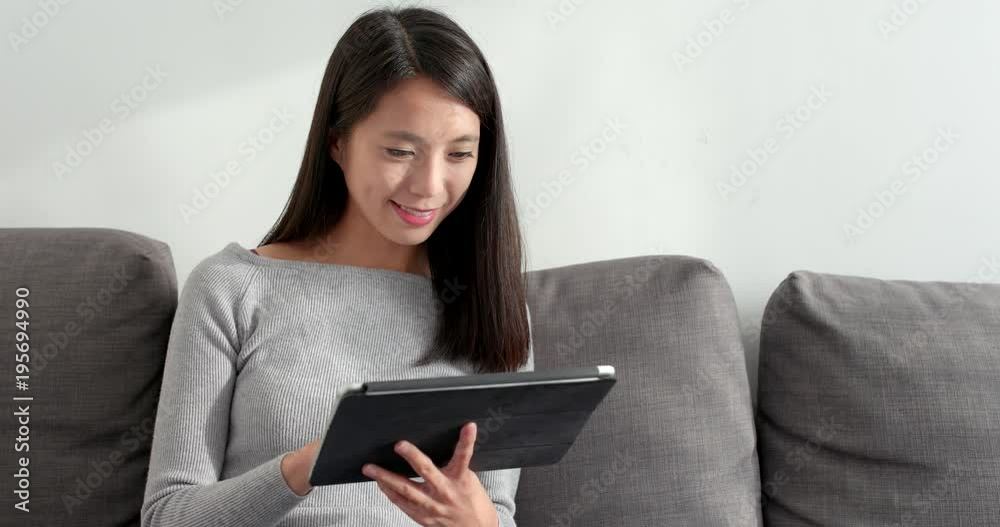 Woman using tablet for online at home Woman using tablet for online at home