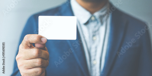 Man holding white business card Man wearing blue shirt and showing blank white business card. Blurred background. Horizontal mockup  Smart asian business Person Professional Occupation cheerful