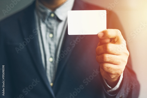 Man holding white business card Man wearing blue shirt and showing blank white business card. Blurred background. Horizontal mockup  Smart asian business Person Professional Occupation cheerful