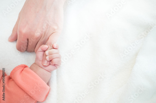 New Born Baby hand hold little finger of mom: concept of love, take care, parent relationship