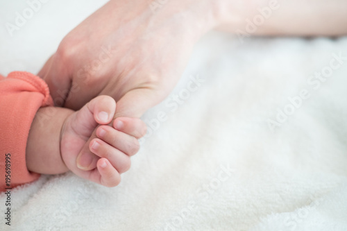 New Born Baby hand hold little finger of mom: concept of love, take care, parent relationship