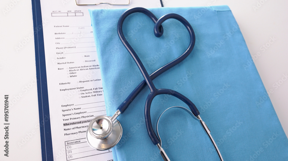 A stethoscope shaping a heart on a medical uniform, closeup A stethoscope shaping a heart on a medical uniform, closeup