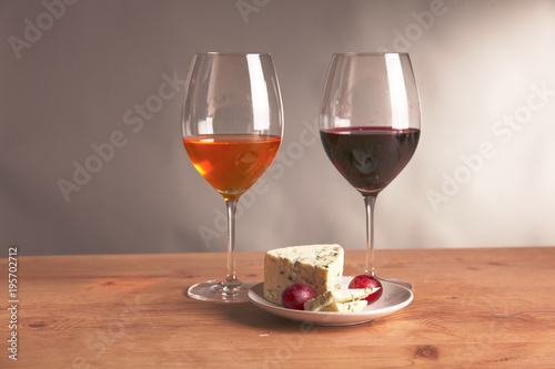 still life with glass and bottle of wine, cheese and grapes