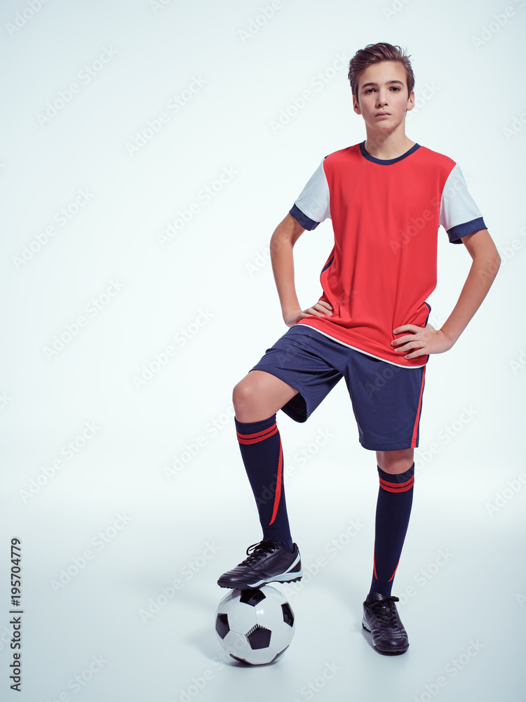 Photo of teen boy in sportswear holding soccer ball Photo of teen boy in sportswear holding soccer ball