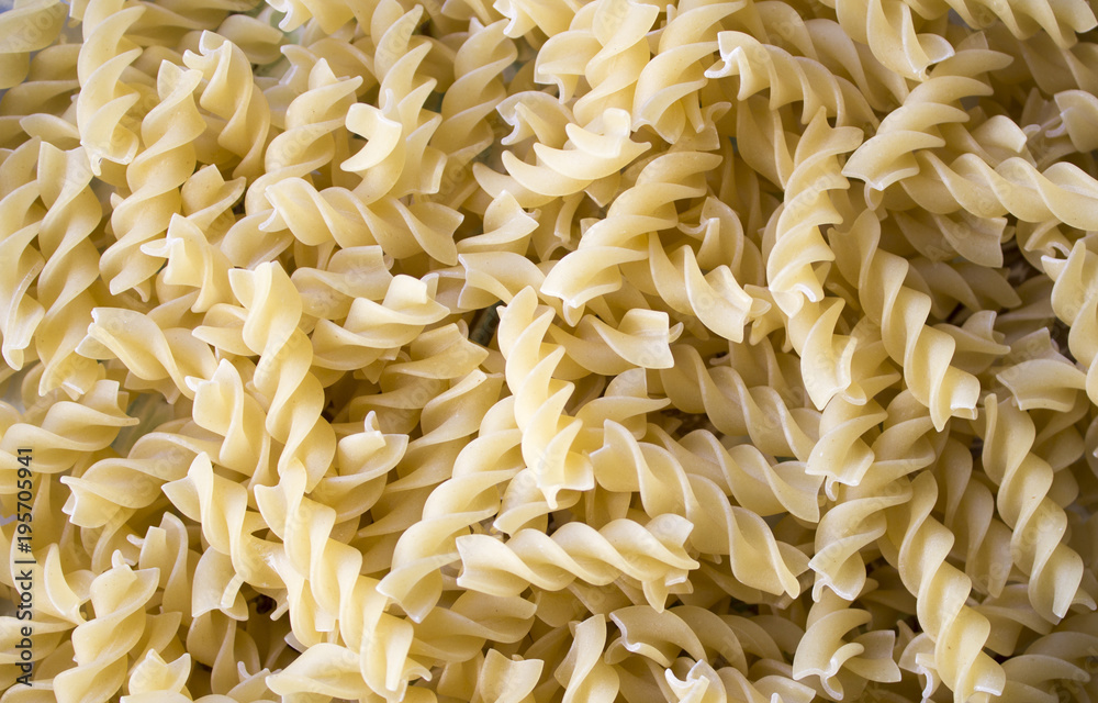 Dry pasta background, healthy food, yellow background Dry pasta background, healthy food, yellow background