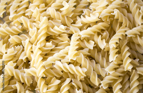 Dry pasta background, healthy food, yellow background