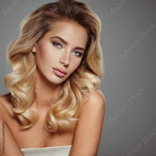 Photo of a beautiful young blond woman with curly hair