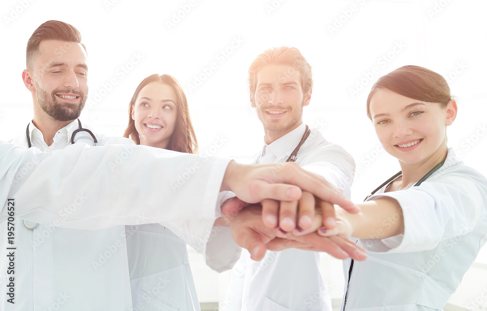 Doctors and nurses in a medical team stacking hands Doctors and nurses in a medical team stacking hands