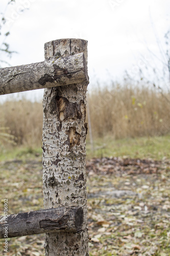 Wooden fence near the river. connection of beams