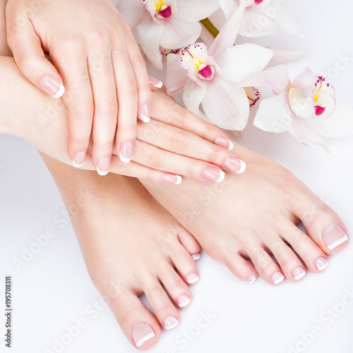 female feet at spa salon on pedicure and manicure procedure