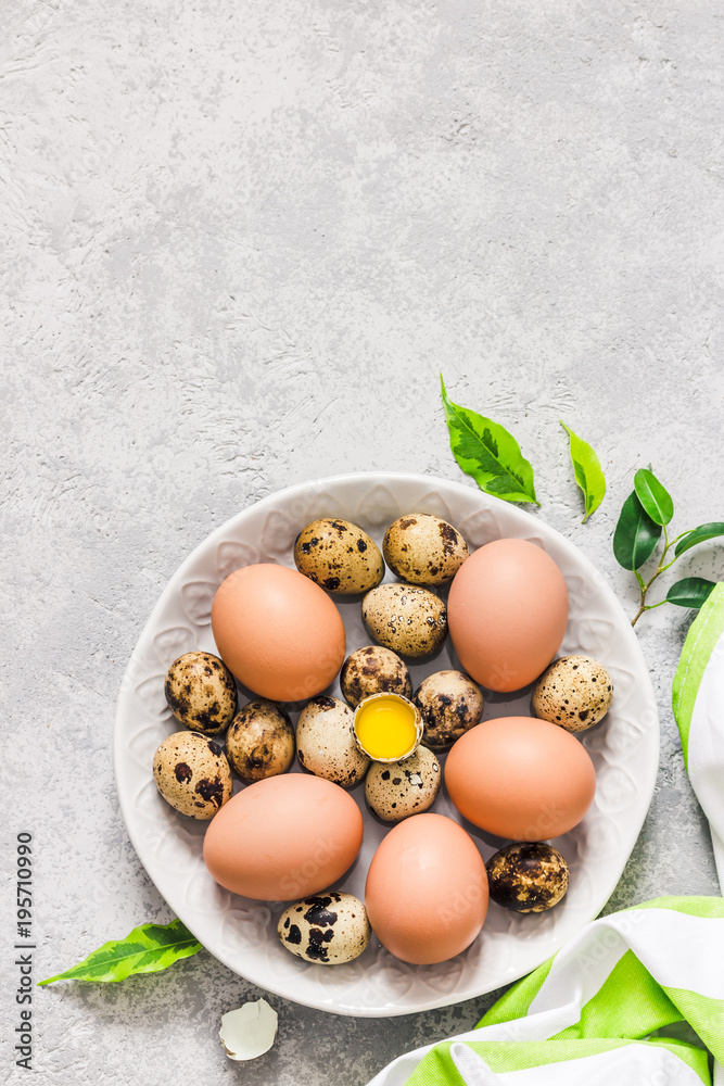 Easter eggs plate on concrete background,spring holiday decoration. Top view, space for text. Easter eggs plate on concrete background,spring holiday decoration. Top view, space for text.