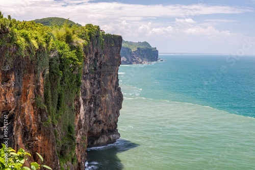 Tropical green rocks of Java island coast. Indonesia. Version 2.