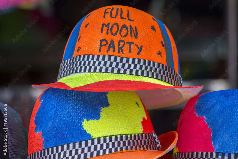 Fototapeta premium Decorated colorful hats sold on the beach before of the Full moon party on the island of Koh Phangan, Thailand