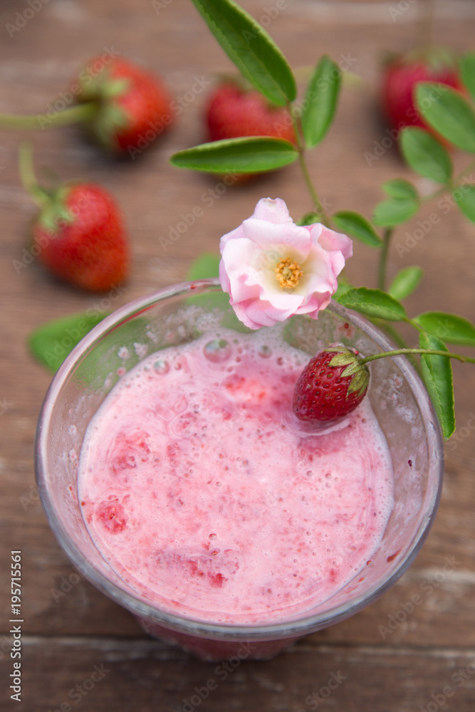 Strawberry milk and rose on wood table Strawberry milk and rose on wood table