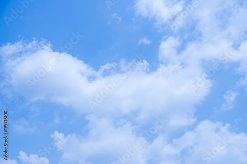 Blue sky background with white clouds.