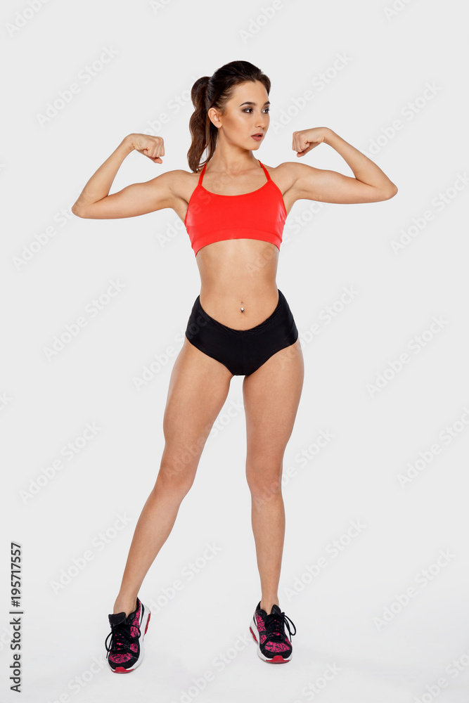 Slender beautiful girl shows muscles of hands Slender beautiful girl shows muscles of hands