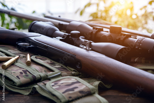 Hunting equipment on old wooden background.