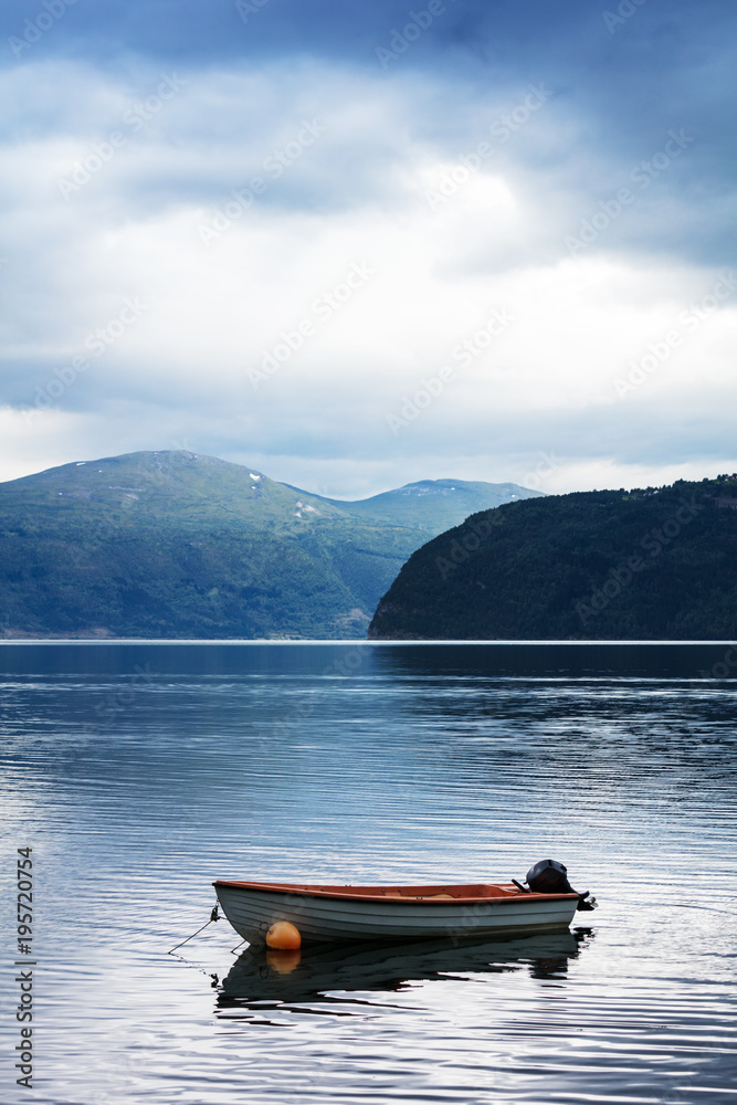 boat on water fjord with mountains in Norway boat on water fjord with mountains in Norway