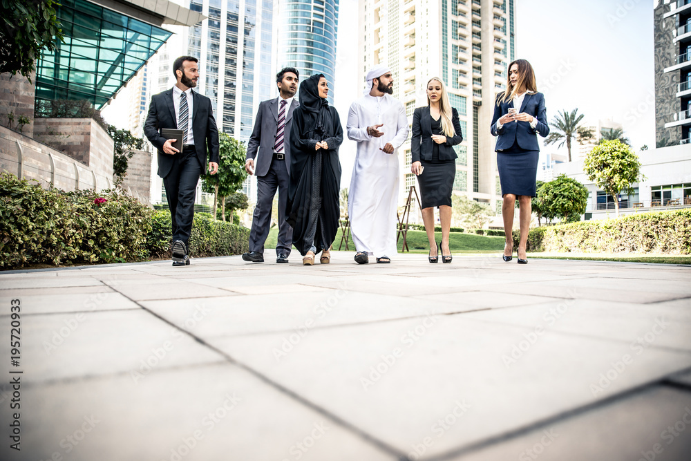 Arabic and western business people speaking about investments Arabic and western business people speaking about investments