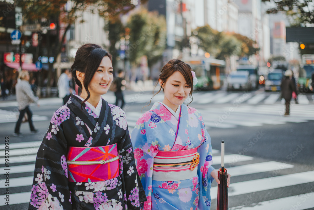 Two japanese girls wearing kimonos traditional clothes, lifestyle moments