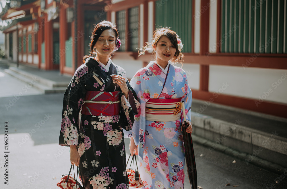 Two japanese girls wearing kimonos traditional clothes, lifestyle moments