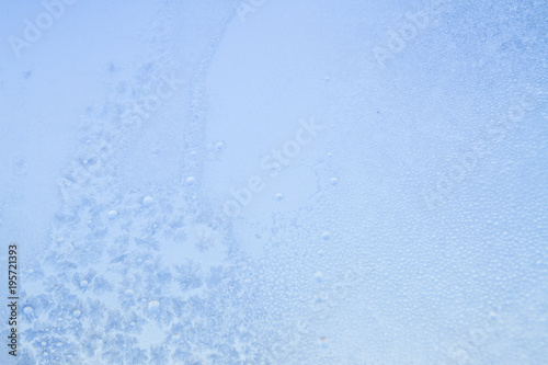 Winter frosty patterns on the frozen ice window