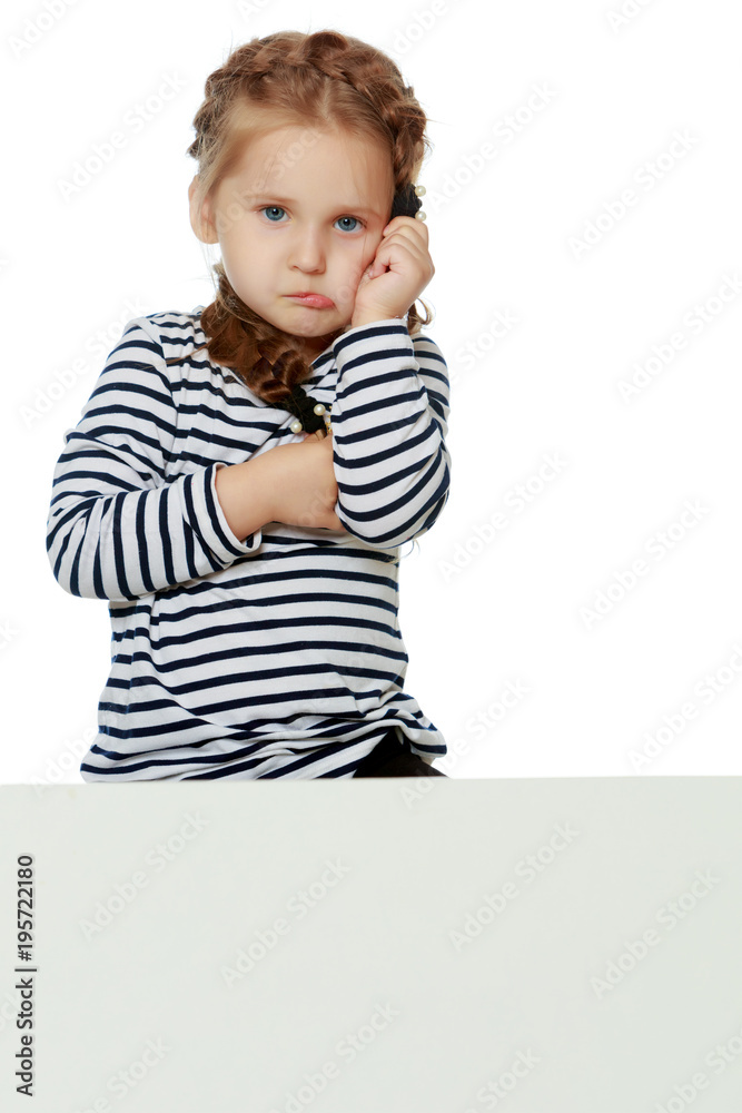 A little girl is looking from behind an empty banner. A little girl is looking from behind an empty banner.