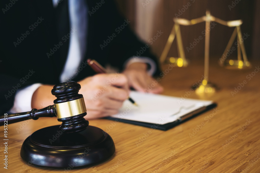Judge gavel with Justice lawyers, Businessman in suit or lawyer working on a documents. Legal law, advice and justice concept Judge gavel with Justice lawyers, Businessman in suit or lawyer working on a documents. Legal law, advice and justice concept