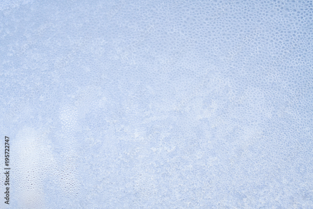 Winter frosty patterns on the frozen ice window