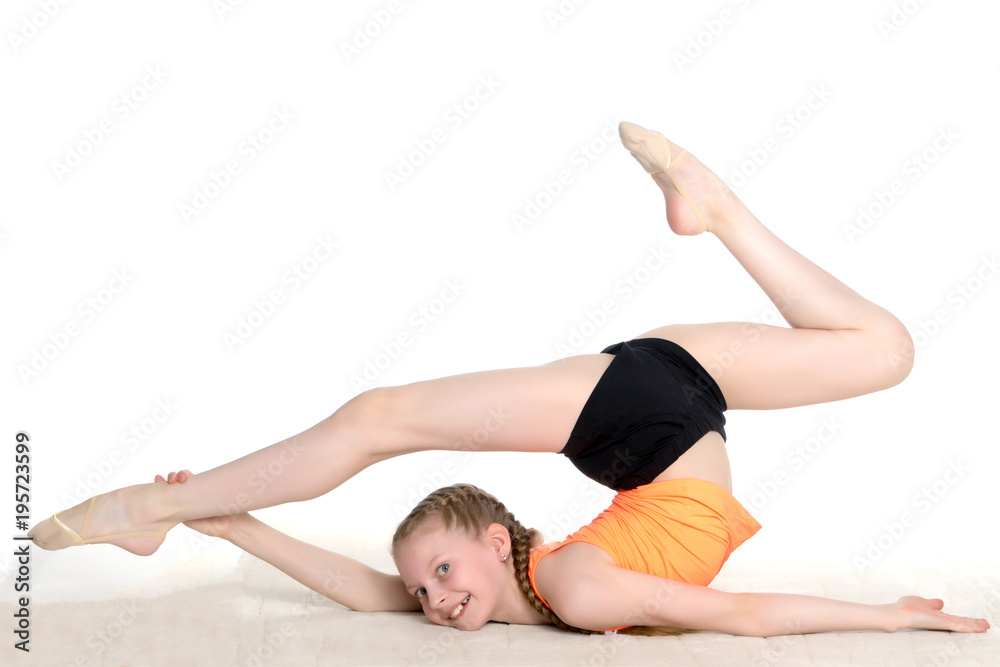 The gymnast performs an acrobatic element on the floor. The gymnast performs an acrobatic element on the floor.