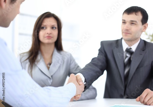 handshake business partners in the workplace