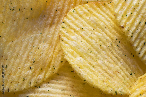 Yellow corrugated potato chips, macro photography, background, texture