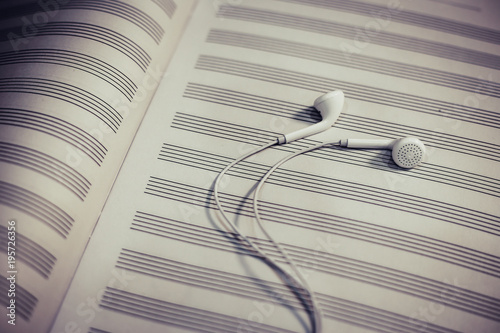 Headphones on the blank music notes paper