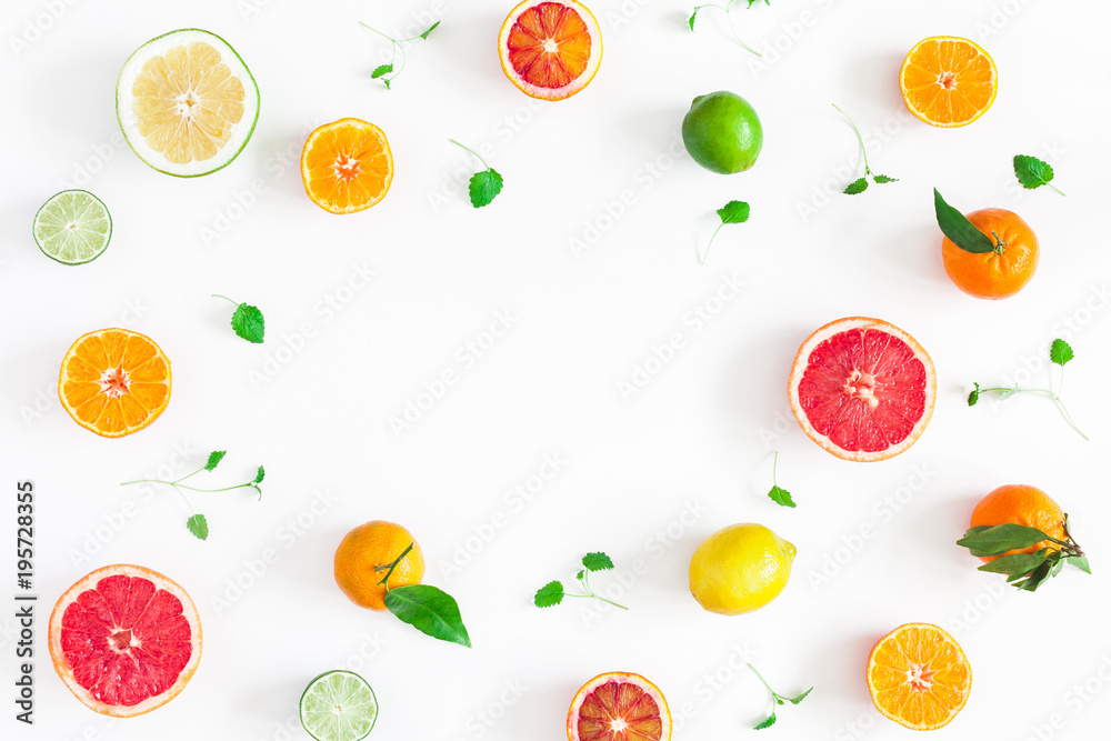 Naklejka Fruit background. Colorful fresh fruits on white table. Orange, tangerine, lime, lemon, grapefruit. Flat lay, top view, copy space