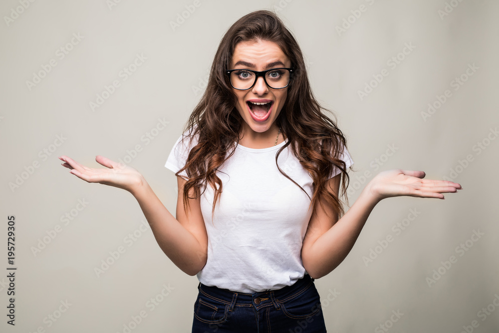 Portrait of shocked woman with mouth open looking away isolated on a gray background Portrait of shocked woman with mouth open looking away isolated on a gray background