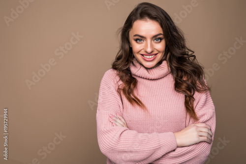 Beautiful young smile woman portrait isolated on brown background