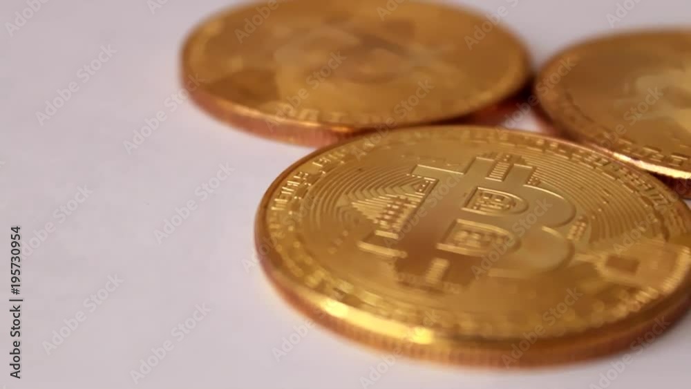 three gold coins bitcoins, spinning on white background three gold coins bitcoins, spinning on white background