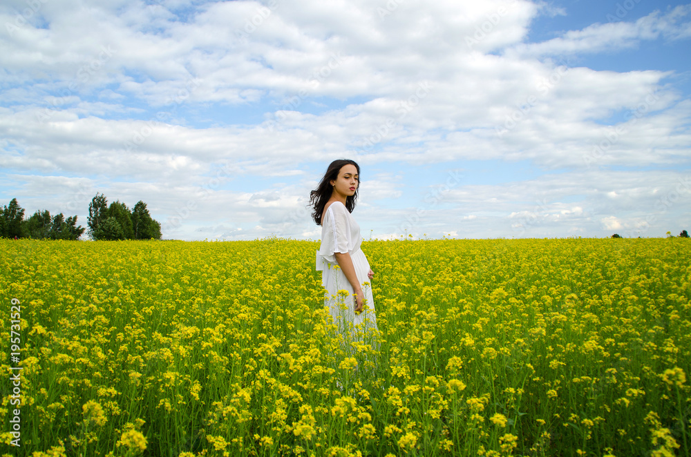 beautiful young girl in a white dress in a field of flowers beautiful young girl in a white dress in a field of flowers